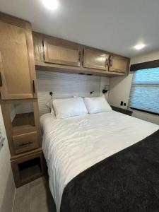 a bedroom with a large bed in an rv at Buffalo Drift Tiny Home in Interior
