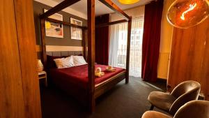a bedroom with a bed with a mirror and a chair at Warsoliv Apartament Premium 332 in Warsaw