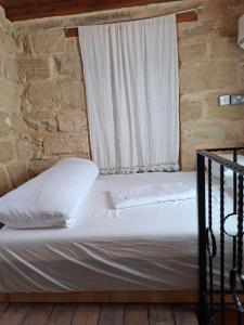 a bed in a room with a window at King's Hill Traditional House in Galinoporni