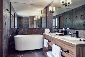 a bathroom with a large tub and a large mirror at Frida by Viadora in Mexico City