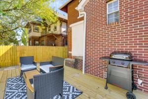 a backyard with a grill and chairs and a house at 5 Mi to Dtwn Detroit Pet-Friendly Edison Home in Highland Park