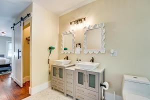a bathroom with two sinks and two mirrors at 5 Mi to Dtwn Detroit Pet-Friendly Edison Home in Highland Park +32 photos