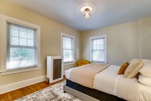 a bedroom with a bed and three windows at 5 Mi to Dtwn Detroit Pet-Friendly Edison Home in Highland Park