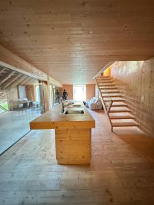 a kitchen with a sink and a staircase in a room at Charming duplex in historic farm Fribourg in Bonnefontaine
