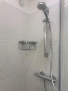 a shower with a shower head in a bathroom at La petite Catène in Le Havre