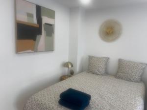 a bedroom with a bed with a blue pillow on it at La petite Catène in Le Havre