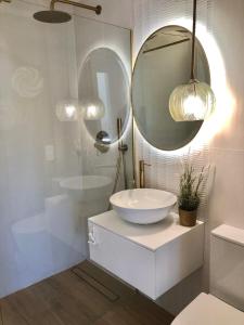 a bathroom with a sink and a mirror at Charming oceanfront property in Casas Devesa