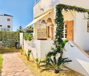 a house with ivy growing up the side of it at Charming oceanfront property in Casas Devesa