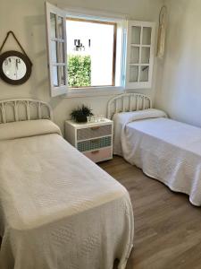 a bedroom with two beds and a window at Charming oceanfront property in Casas Devesa