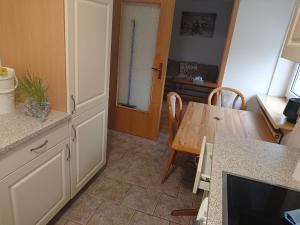 a kitchen with a table and a dining room at Ferienwohnung Erlangen Urlaub mitten in Franken in Wachenroth