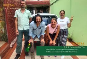 a group of people standing in front of a car at Hostal Cartagonova - Habitaciones privadas y amplias cerca a zonas turísticas in Cartagena de Indias