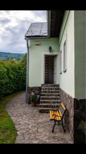 a bench sitting in front of a house at Holiday Home Banská Štiavnica in Banská Štiavnica