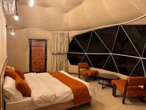 a bedroom with a large bed and a table and chairs at Bedouin Camp&tour in Wadi Rum