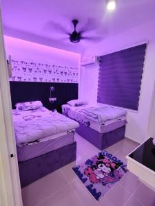 a bedroom with two beds and a purple ceiling at Kuromi Homestay Port Dickson Ground Floor in Port Dickson