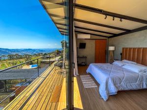 Un pat sau paturi într-o cameră la Cabana Encanto do Sapucaí
