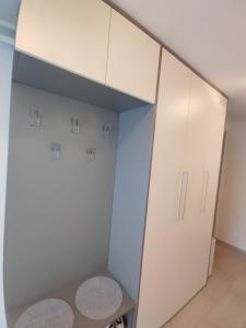a closet with white cabinets and a table at Modern appartement with big terrace in Ljubljana in Ljubljana +9 photos