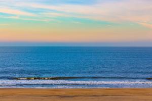 a view of the ocean from a beach at sunset at Adagio 501 in Ocean City