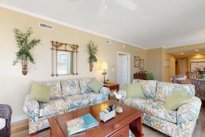 a living room with two couches and a table at Adagio 501 in Ocean City
