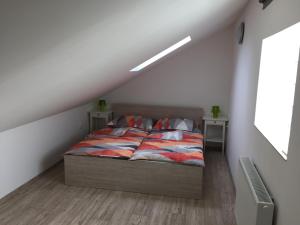 a bedroom with a bed and two night stands at Apartment Lidická Slavkov, 4 person in Slavkov u Brna