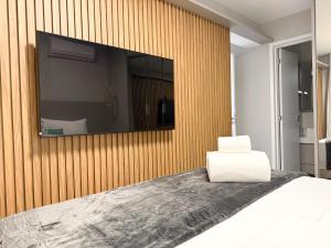 a bedroom with a large mirror on a wooden wall at STAY ID Vida Urbana in Goiânia +28 photos