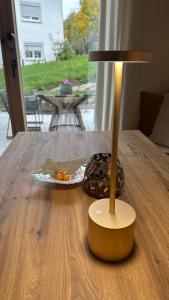 a lamp sitting on top of a wooden table at 5 Sterne Ferienwohnung Villa Barka in Eppenschlag