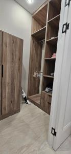 a dressing room with wooden cabinets and a closet at Сдаётся квартира для иностранцев in Taraz +3 photos
