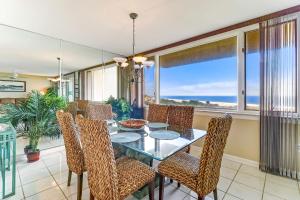 a dining room with a glass table and chairs at Oceanfront 3 Bedrooom BeachWalker Condo in Amelia Island