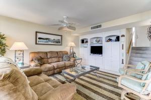 a living room with a couch and a table at Oceanfront 3 Bedrooom BeachWalker Condo in Amelia Island