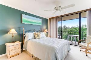 a bedroom with a bed and a balcony at Oceanfront 3 Bedrooom BeachWalker Condo in Amelia Island +32 photos