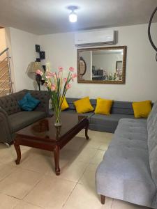 a living room with a couch and a coffee table at Residencia en Mitras Poniente García in Monterrey
