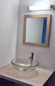 a glass sink in a bathroom with a mirror at Le Mohana - L'évasion tropicale de l'Est in Saint-André