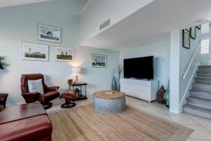 a living room with a tv and a couch and chairs at Oceanfront 2 Bedrooom with sleeping loft in Franklintown