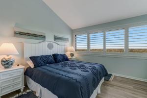 a bedroom with a bed and a window at Oceanfront 2 Bedrooom with sleeping loft in Franklintown +23 photos
