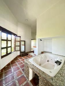 a large bathroom with a large tub in a room at Casa Horizonte Ocean view and Carrizalillo access in Puerto Escondido