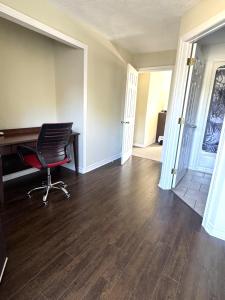 an empty room with a desk and a chair at Lincoln Inn Fredericton in Fredericton