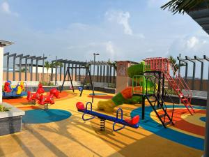 a playground with a slide at Orchid 001Airport view55 TVCoffee maker in Pune