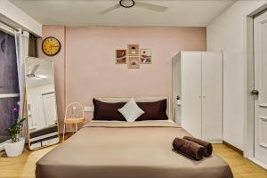 a bedroom with a large bed and a clock on the wall at Orchid 001Airport view55 TVCoffee maker in Pune