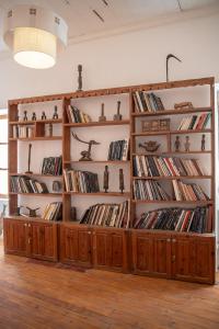 a room with wooden book shelves filled with books at Maison Crespin in Dakar