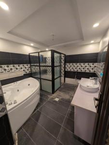a bathroom with a tub and a sink at Dream house 