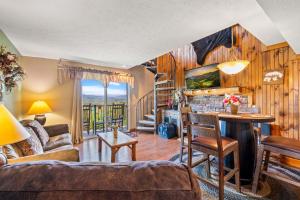 a living room with a couch and a table at Mountain Top View in Pittman Center +18 photos