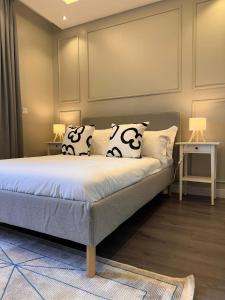 a bed with pillows on it in a room at Behomu Apartments Kampala in Kira