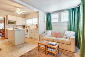 a living room with a couch and a table at Stroll to Bradenton Riverwalk! Stylish Apartment in Bradenton