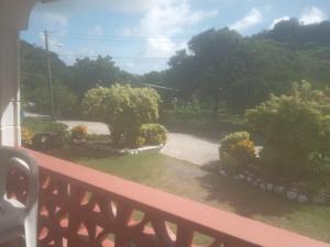 a view of a garden from a balcony at Little paradise in Saint Georgeʼs +5 photos