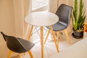 two chairs and a white table in a room at HayyaHayya Villas in Ocoy