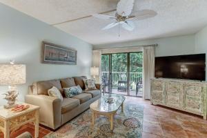 a living room with a couch and a flat screen tv at Two Bedroom Beachwood Condo 2118 in Franklintown