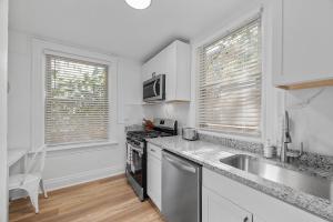a kitchen with a sink and a stove top oven at Pittsburgh Shadyside 2A Bright and Stylish Private Bedroom with Shared Bathroom in Pittsburgh