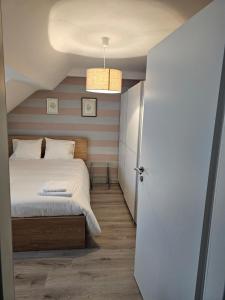 a bedroom with a bed and a hallway with a door at private apartment in Luxembourg +7 photos