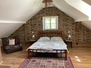 a bedroom with a bed and a brick wall at Holiday Home Banská Štiavnica in Banská Štiavnica