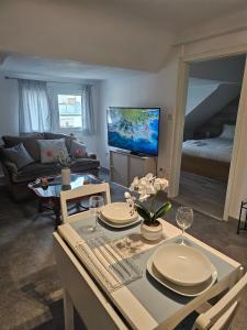 a living room with a table with chairs and a couch at private apartment in Luxembourg