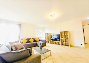 a living room with a couch and a table at Central&comfy 2BR Flat with parking in Luxembourg
